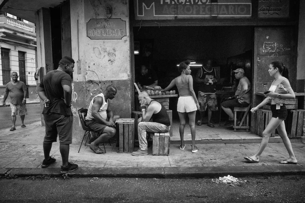People gather outside a corner cafe